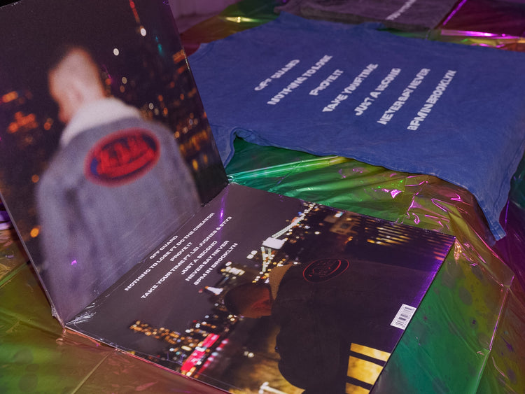 Vinyl records and tees laid out at the release