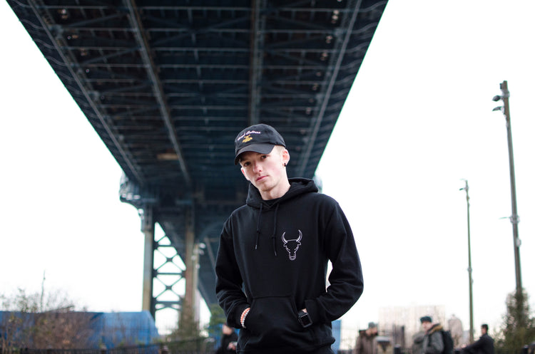 Black bull logo hoodie under a New York bridge