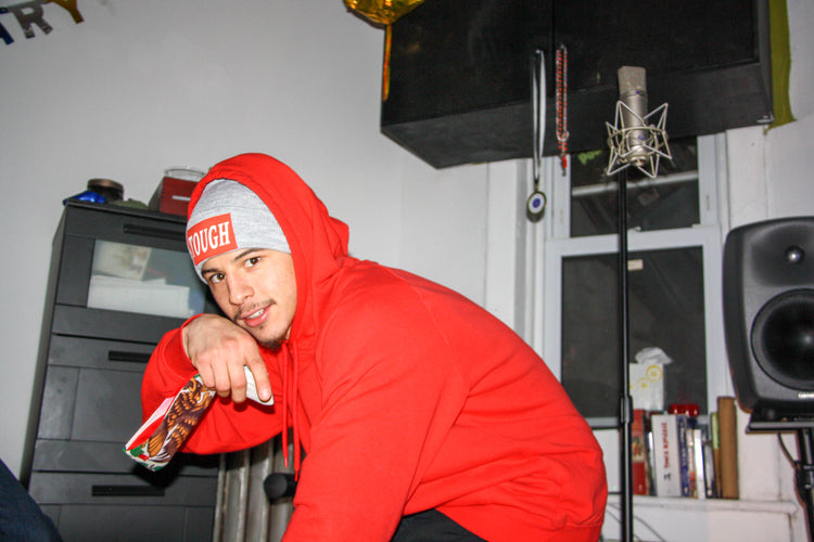Red hoodie and Tough beanie in the studio